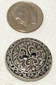 a two-hole antiqued metal button
